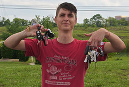 A man holding many car keys