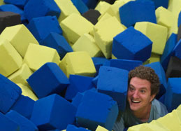 Chris Tompkins having fun in a pit full of foam