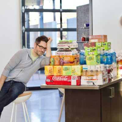 Andy Whitaker sat next to many boxes of beverages and snacks